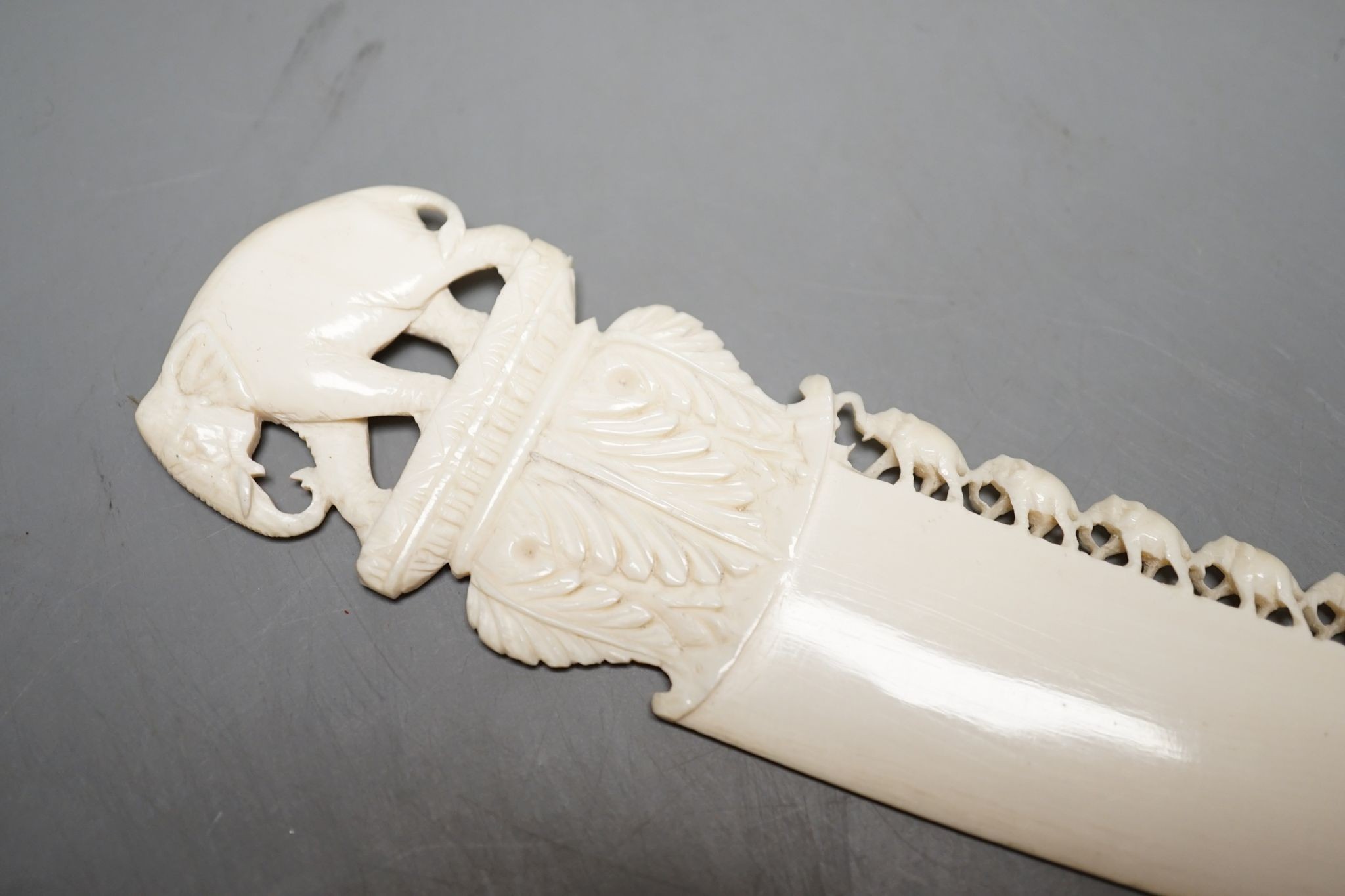 An Indian ivory letter opener, 38cm, and a Ganesh figure
